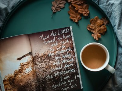 flat lay photography of cup and book